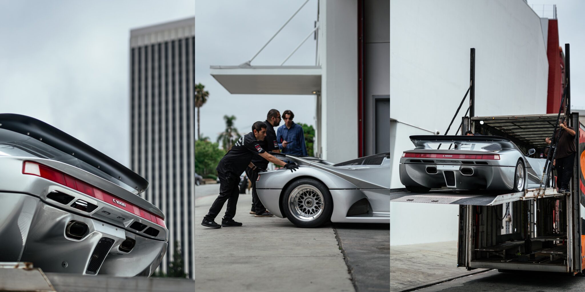 A silver Lotec C1000 sports car is being unloaded from a truck, assisted by several people outside a modern building under cloudy skies—a scene worthy of Petrolicious Film Friday.