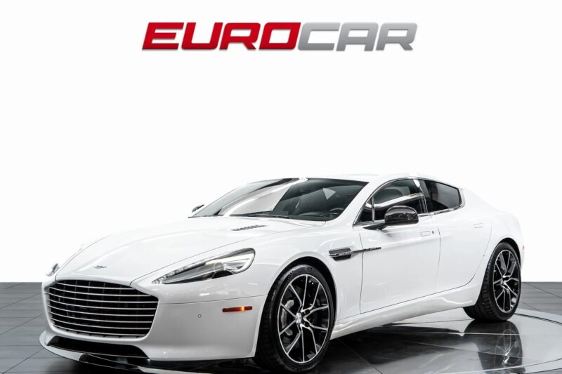 A white luxury sedan, part of our affordable luxury sedans collection, is parked indoors with the "Eurocar" logo displayed above it on the wall.