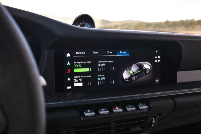 Digital car dashboard in the Review: 2025 Porsche 911 Carrera GTS T-Hybrid Electrifies Potent Performance displays battery charge at 93%, temperature at 36°C, and shows a graphic of the vehicle’s energy system.