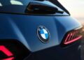 Close-up of the rear of a blue BMW vehicle, highlighting the BMW logo and modern taillight design—an exciting glimpse as the BMW iX3 launches the Neue Klasse era with a 400-mile range and 463 HP.