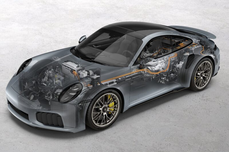 A semi-transparent sports car reveals its internal mechanical components, including the engine and drivetrain, showcasing technology like the Most Powerful Production 911: 2026 Porsche 911 Turbo S T-Hybrid Packs 701HP, all on a gray surface background.