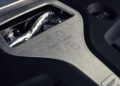 Close-up of a 4.0-liter twin-turbo V8 engine cover from the 2026 Aston Martin DBX S First Drive: The Best Super SUV Gets Even Better, highlighting metallic detailing and engraved specifications.