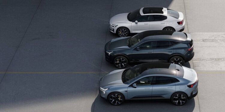 Three modern cars, two sedans and one SUV, are parked side by side on a clean, gray pavement under partial sunlight.