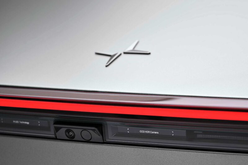 Close-up of the rear end of a Polestar 5, debuting at IAA 2025 as the brand’s first true flagship EV GT, showcasing its logo, red light strip, and trunk-integrated cameras or sensors.