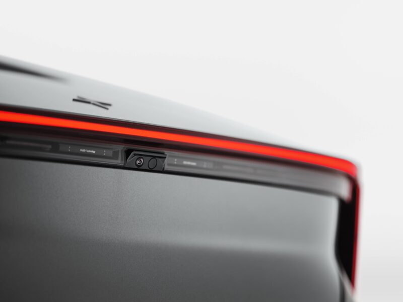 Close-up of a car’s rear with a red LED tail light strip and a rearview camera, showcasing details on the Polestar 5 Debuts at IAA 2025 as Brand’s First True Flagship EV GT.