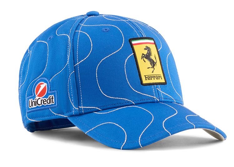 From the Limited-Edition Collection, this blue Ferrari cap features white curved lines, a yellow Ferrari logo patch on the front, and a UniCredit logo on the side—part of the exclusive PUMA x Ferrari collaboration.