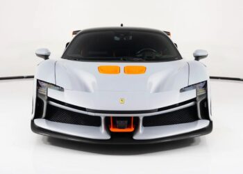 Front view of a silver Ferrari sports car with orange accents and black roof, showcasing aerodynamic features in a well-lit studio. This standout model ranks among the Most Expensive Ferraris, photographed against a white background.