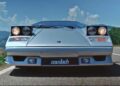 Front view of a silver Lamborghini Countach with pop-up headlights raised, parked on a road under a blue sky with scattered clouds—a true icon featured in Polo Storico's Heritage Films.