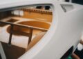 Close-up view of an unfinished Lamborghini interior, showing exposed framework and structural components with no seats or upholstery installed—capturing the raw stage often highlighted in Polo Storico heritage films.