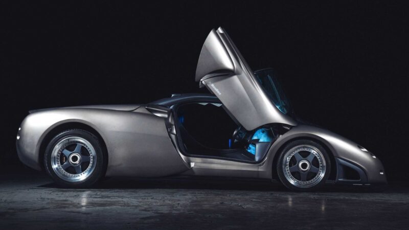 1-of-1 Lamborghini Pregunta sports car with gullwing door open, photographed in profile view against a dark background by Broad Arrow.
