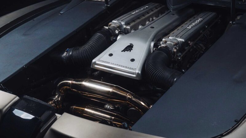 Close-up view of a Lamborghini V12 engine with visible intake manifolds, piping, and engine cover featuring the Lamborghini logo—an exclusive detail from the 1-of-1 Lamborghini Pregunta offered by Broad Arrow.