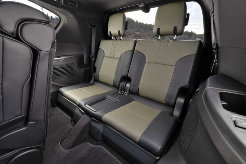 The image shows the third-row seats of a vehicle interior, featuring two-tone upholstery, seat belts, and headrests—attributes praised in our Review: 2025 Lexus LX 700h Overtrail 4WD as highly capable yet moderately practical.