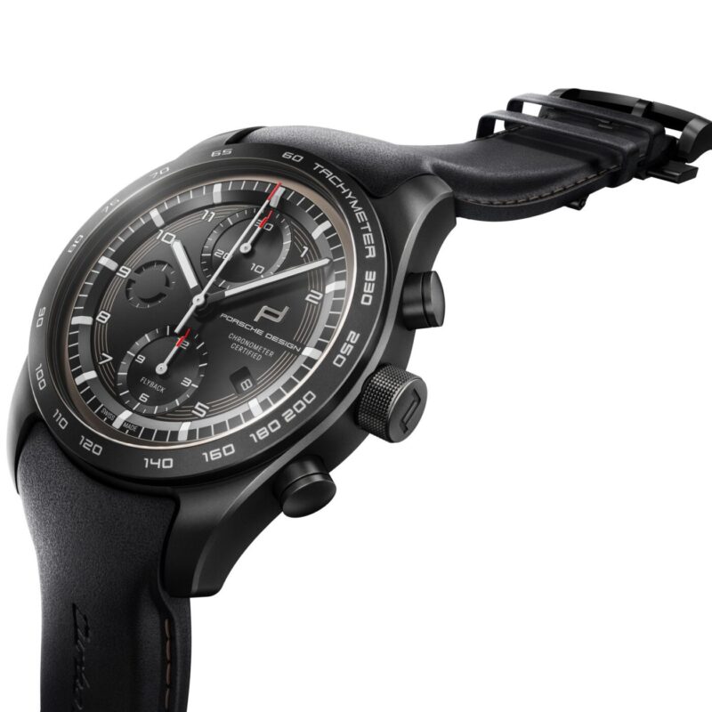 Black Porsche Design Custom-Built Chronograph watch with a black leather strap, tachymeter bezel, and three subdials, shown at an angle on a white background—crafted in the spirit of the iconic 911 Turbo S.