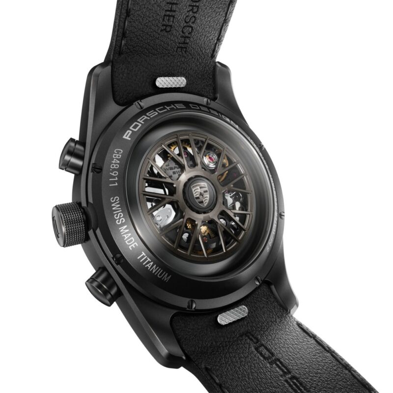 Close-up view of the back of a Porsche Design Custom-Built Chronograph, inspired by the 911 Turbo S, showing the exposed automatic movement, branding, and a black leather strap.