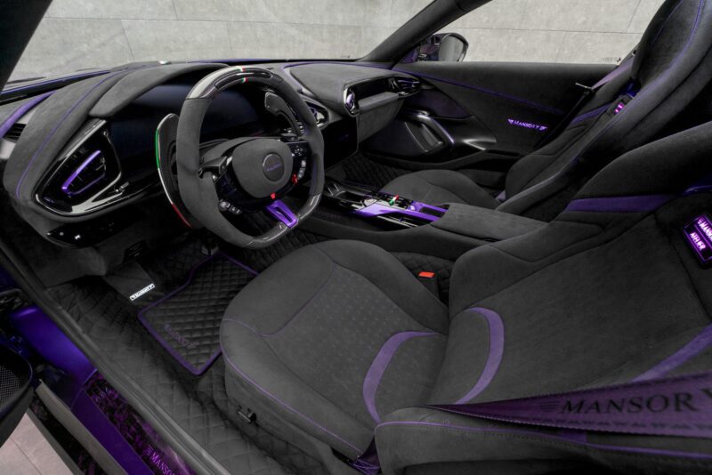 Luxury sports car interior with black and purple accents, leather and suede seats, digital dashboard, and MANSORY branding—echoing the style of the MANSORY Previews Ferrari 12Cilindri-based Equestre Ahead of Monaco Yacht Show.