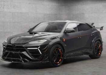 A black Lamborghini Urus SUV with orange accents and a custom Mansory body kit is parked in a modern, gray-tiled showroom.