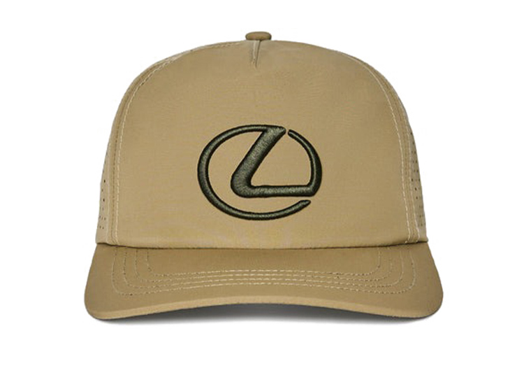 A beige baseball cap from the Malbon Golf x Lexus Capsule Collection, featuring a black embroidered Lexus logo on the front.