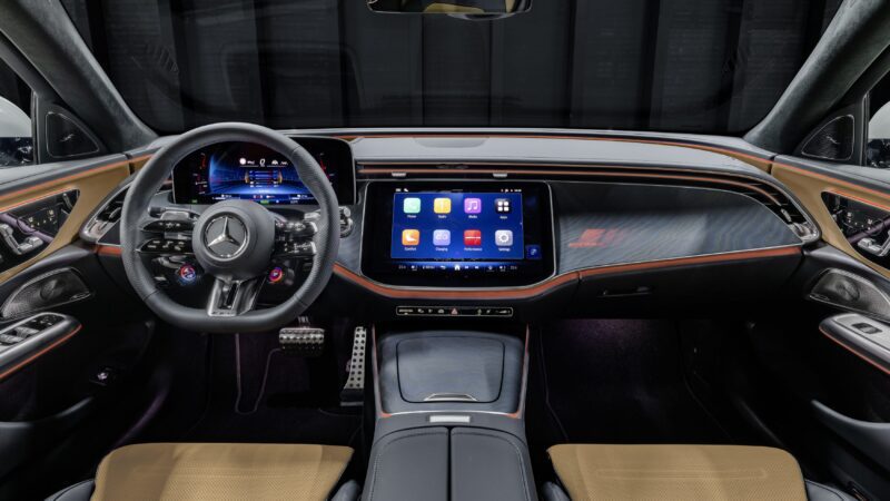 Interior view of a Mercedes-Benz car, similar to the model featured as Mercedes-AMG reveals pricing for the new E 53 HYBRID Wagon, showcasing a digital instrument cluster, touchscreen display, leather seats, and ambient lighting.