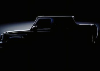 A pickup truck is shown in silhouette against a dark background, echoing the intrigue as Mercedes teases the G-Class Cabriolet revival with four doors instead of two, subtle lighting highlighting its outline and features.