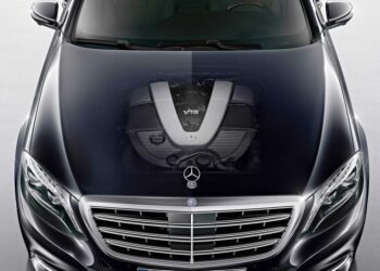 A 2030 Mercedes-Benz car with a transparent hood effect reveals the powerful V12 engine underneath.
