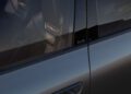 Close-up of a blue 2026 Audi A6 car door and window, highlighting the Audi and A6 badges on the trim and an S line logo on the seat inside. Curious about the Audi A6 price? This stylish model blends luxury with performance.