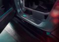 Close-up view of a car's open door, showcasing the interior door sill with a signature plaque and visible roll cage structure, highlighting its exclusive Edition W16 status.