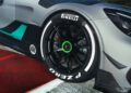 Close-up of a Mercedes-AMG GT2 Edition’s front wheel with black alloy rim, Pirelli P Zero tire, and white sidewall lettering, parked next to a red and white race track curb.