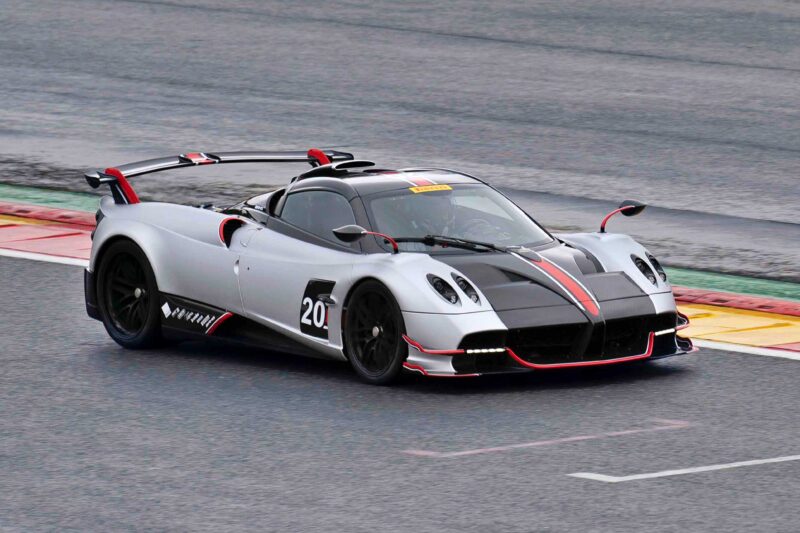 A silver sports car with black and red accents, marked with the number 20 on its side, races on a track—capturing the excitement as Pagani prepares to showcase four hypercar icons at the upcoming 9th Historic Minardi Day in Imola.