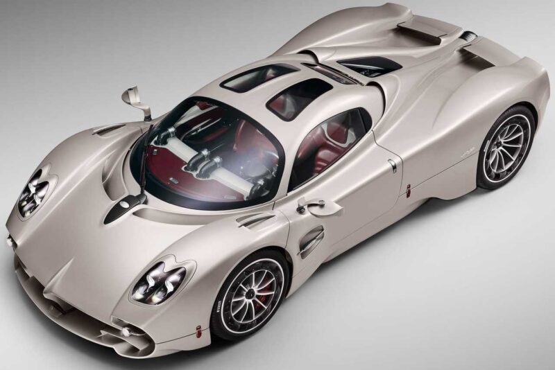 Overhead view of a silver sports car with a sleek aerodynamic design, red and black interior, and distinctive curves—reminiscent of the Pagani models set to showcase four hypercar icons at the upcoming 9th Historic Minardi Day in Imola.