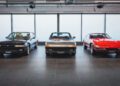 Three classic Ferrari cars are displayed side by side in a modern showroom with large windows and tiled flooring, reminiscent of the elegance found at an RM Sotheby’s Zurich auction.