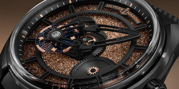 Close-up of a limited edition Ulysse Nardin wristwatch with exposed gears, copper-toned textured dial, and skeletonized hands inside a black case.