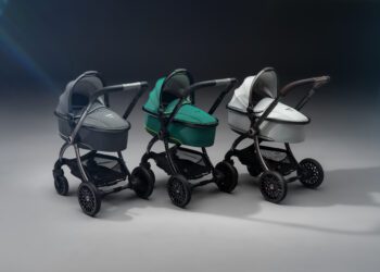 Three modern Aston Martin strollers in gray, green, and white are lined up side by side on a plain, softly lit background—perfect for next generation car lovers.