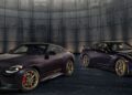 Two black 2026 Nissan Z sports cars with gold wheels sit side by side in a modern, dimly lit room with metallic walls and a dark marble floor, showcasing their 300ZX-inspired design.