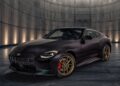 A black Nissan Z Heritage Edition with gold wheels and red brake calipers is parked in a modern, dimly lit circular room with metallic walls and floor, showcasing its 300ZX-inspired design.