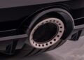 Close-up view of a 2026 Nissan Z’s round metallic exhaust tip with perforated detailing, attached to a black rear bumper near a visible tire—showcasing the model’s 300ZX-Inspired Design.