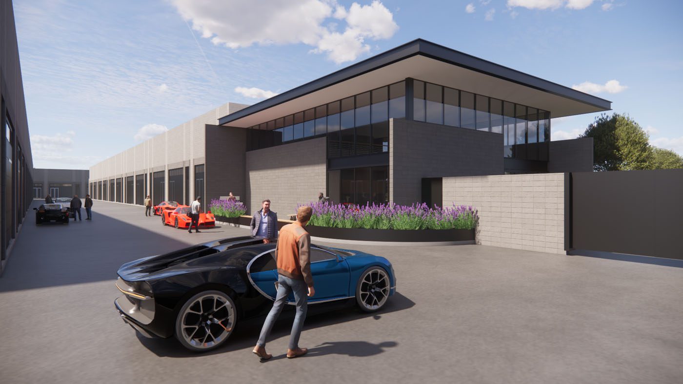 A man stands next to a blue sports car in front of a modern building, with other people and several sports cars visible in the background.