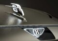 Close-up of a Bentley car hood, featuring the illuminated emblem and hood ornament—hinting at Bentley to reveal more about its upcoming EV and a limited-run model coming before year-end.