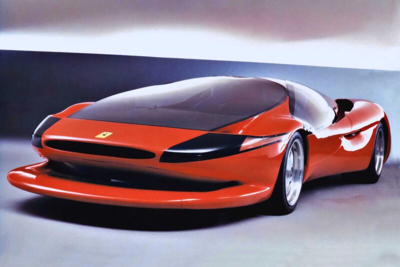 A red, futuristic Ferrari concept car—one of the 1-of-1: Rarest Ferraris In The World—features a sleek, aerodynamic design, black-tinted windows, and minimal front detailing, displayed elegantly in a studio setting.