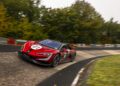 A red race car with the number 01, inspired by electric hypercars like the YANGWANG U9, drives quickly around a curve on a racetrack surrounded by trees.