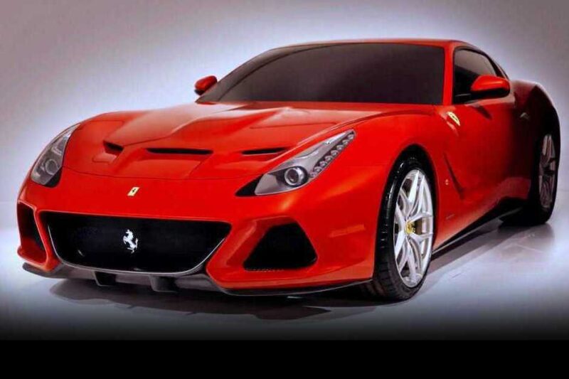 A red sports car with sleek aerodynamic design, low profile, and silver alloy wheels—one of the 1-of-1: Rarest Ferraris In The World—is parked in a well-lit studio setting.