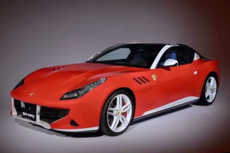 A red Ferrari sports car with white accents, viewed from a front-side angle in a studio, stands as a stunning 1-of-1: Rarest Ferraris In The World.