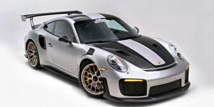 For Sale: 2018 Porsche 911 GT2 RS—last of its kind before electrification—this silver beauty with black accents and a large rear wing is parked on a plain white background.