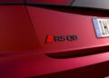Close-up of the rear badge on a red Audi RS Q8, showing the RS Q8 logo and part of a European license plate. Review: 2025 Audi RS Q8 Performance highlights its bold styling and performance-focused details.