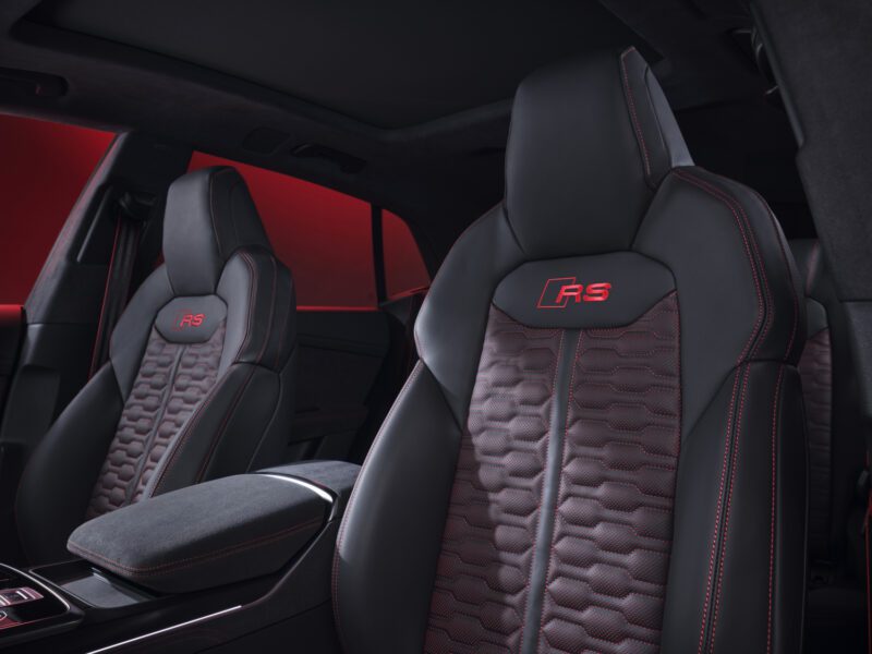 Front seats of the 2025 Audi RS Q8 Performance feature black leather with red stitching, "RS" logos on the seatbacks, and a honeycomb pattern on the seat cushions.