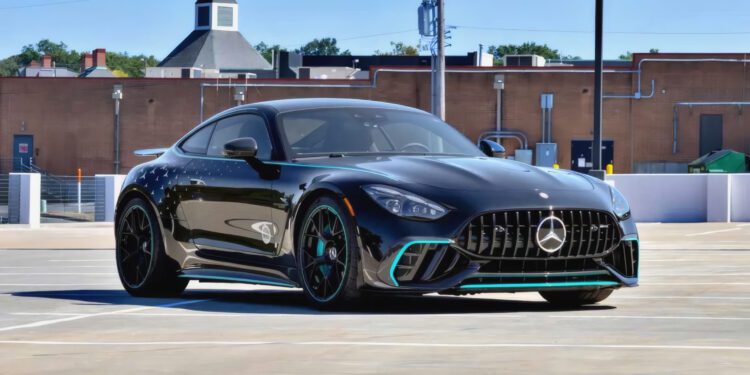 A black Mercedes-Benz AMG GT 63 PRO parked in an empty outdoor parking lot with a brick building in the background, this Collectors Edition is now available for sale.