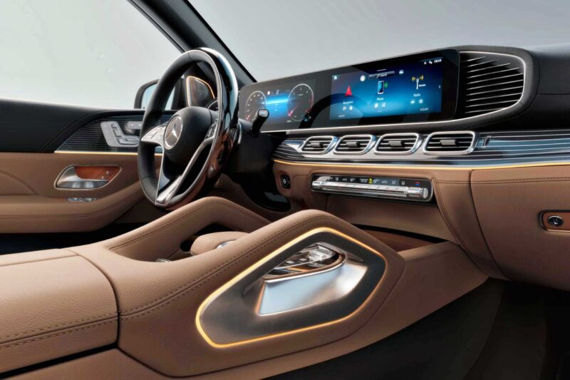 The interior of the 2025 Mercedes-Benz GLS 580 4Matic features tan leather seats, a digital dashboard, and a large infotainment screen for an elevated driving experience.