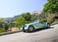 A Morgan Plus Four, celebrating its 75th Anniversary, is parked roadside with the iconic Hollywood sign visible on a hill in the background.