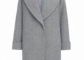 A light gray, knee-length wool coat with wide lapels, long sleeves, and a single hidden front closure, inspired by Sergio Hudson’s signature style, displayed against a white background.