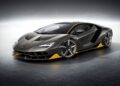 A sleek, black and yellow Lamborghini sports car is parked in a well-lit studio with a reflective floor, celebrating Lamborghini Centro Stile at 20: The Studio Behind Every Modern Bull.
