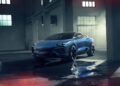 A blue Lamborghini SUV is parked indoors on a wet concrete floor, surrounded by large windows and industrial beams, bathed in soft light—an iconic scene celebrating Lamborghini Centro Stile at 20: The Studio Behind Every Modern Bull.